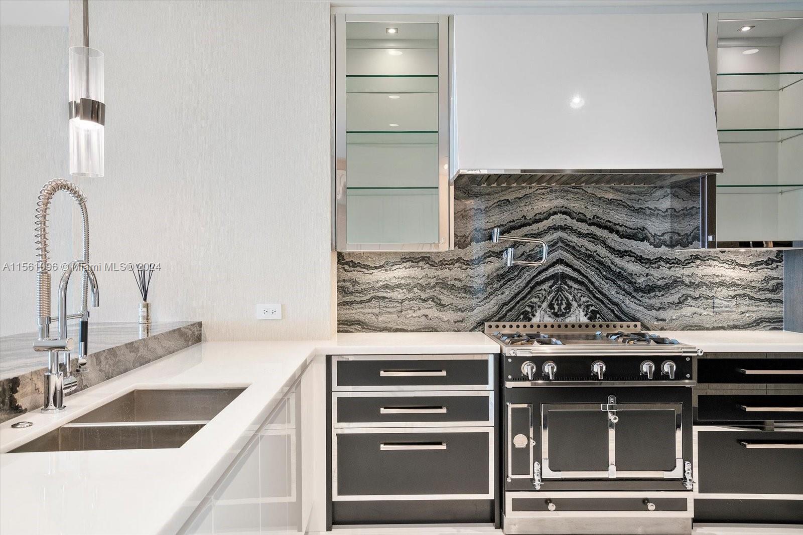 17901 Collins Avenue, Unit 902 Sunny Isles Beach, FL 33160 - Photo 5 of 47 a kitchen with a stove and a sink