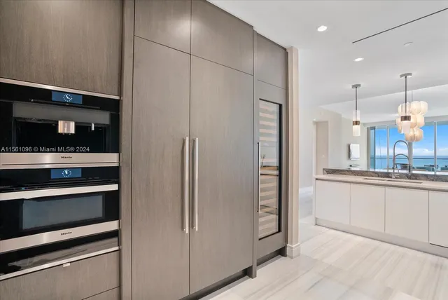 a kitchen with stainless steel appliances a refrigerator and a sink