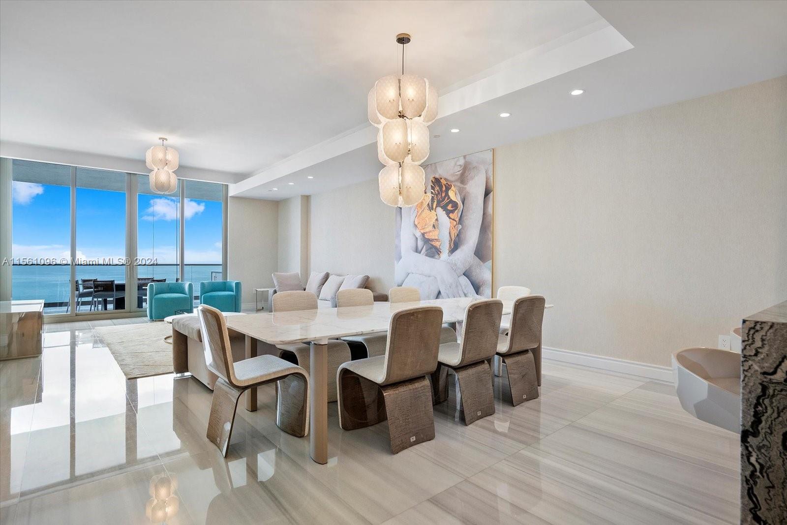 17901 Collins Avenue, Unit 902 Sunny Isles Beach, FL 33160 - Photo 8 of 47 a view of a dining room with furniture wooden floor and chandelier