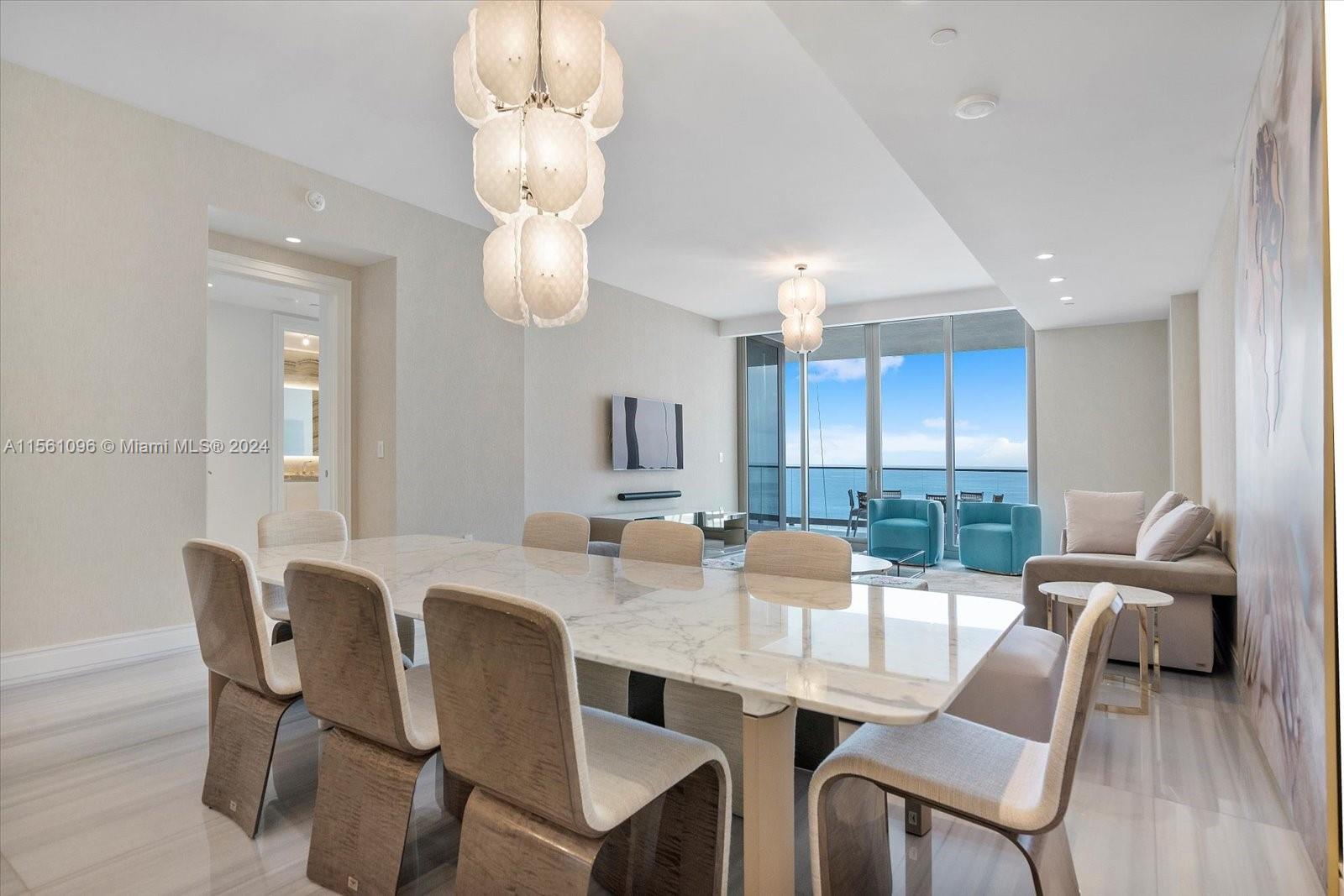 17901 Collins Avenue, Unit 902 Sunny Isles Beach, FL 33160 - Photo 9 of 47 a view of a dining room with furniture and chandelier