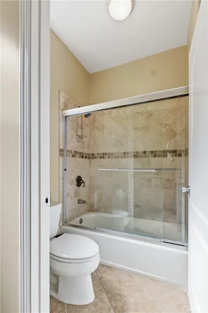 a bathroom with a shower a toilet and a shower