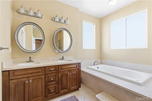 a bathroom with a granite countertop toilet a sink and a mirror
