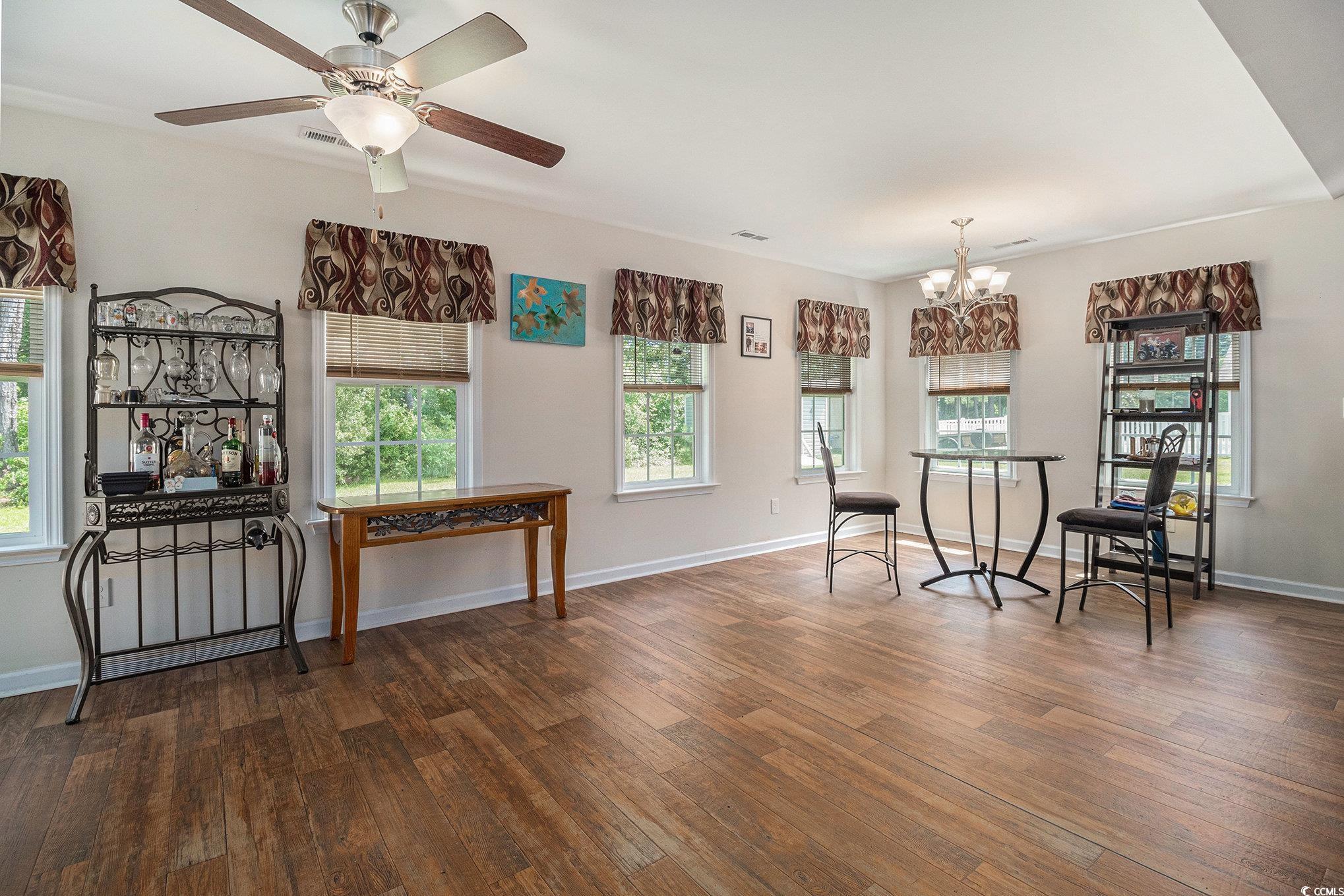 95 Timber Run Drive Georgetown, SC 29440 - Photo 8 of 34 Living area featuring a chandelier, wood-type floo