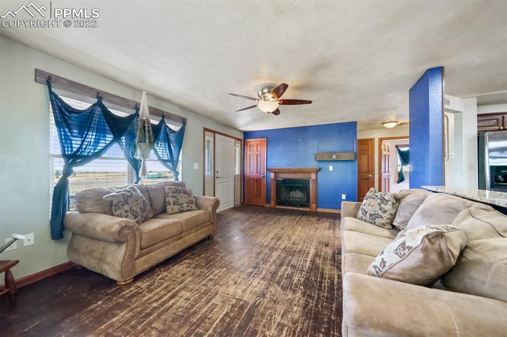 6260 Night Train Lane Yoder, CO 80864 - Photo 15 of 24 a living room with furniture and a fireplace