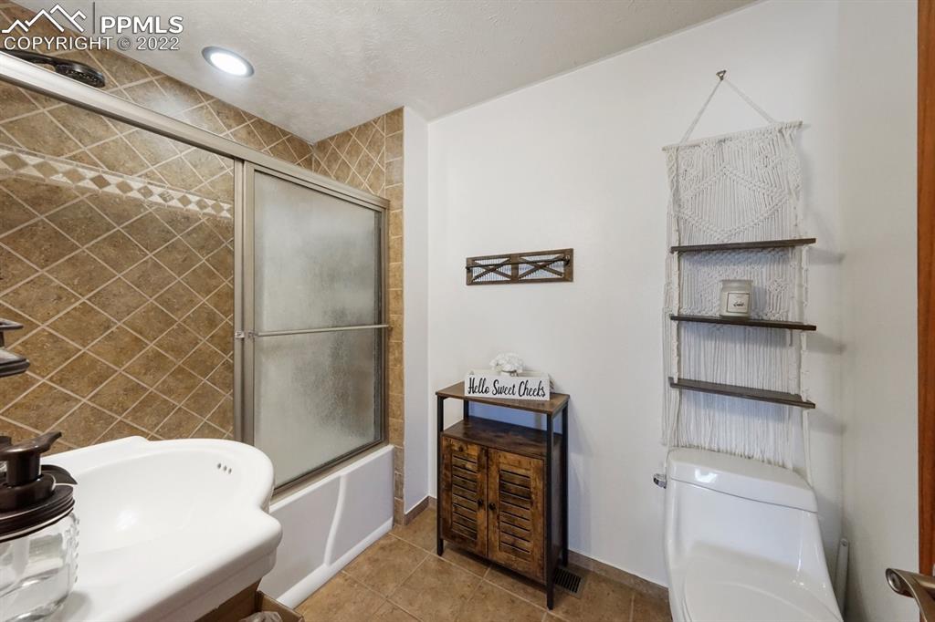 6260 Night Train Lane Yoder, CO 80864 - Photo 21 of 24 a bathroom with a sink toilet and tub