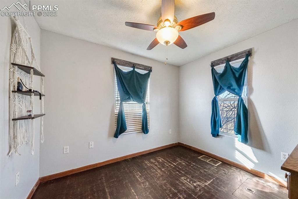 6260 Night Train Lane Yoder, CO 80864 - Photo 22 of 24 a view of an empty room with a window and wooden floor
