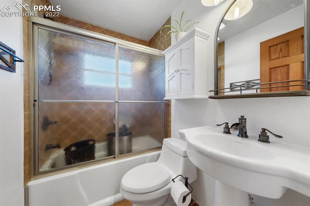 6260 Night Train Lane Yoder, CO 80864 - Photo 23 of 24 a bathroom with a toilet a sink and shower