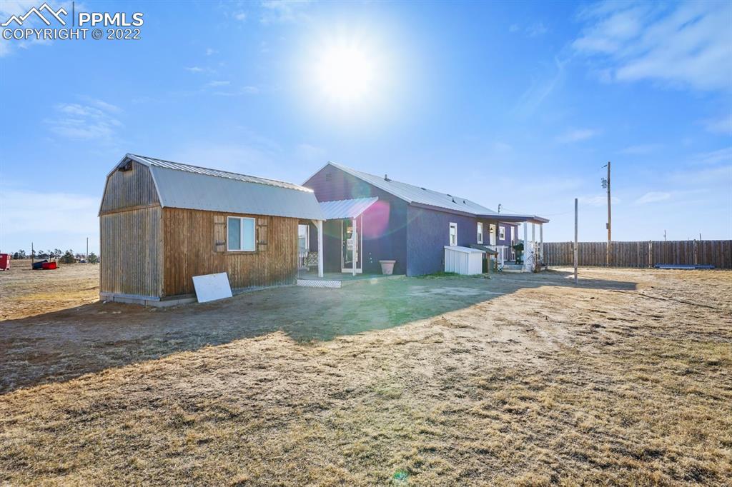 6260 Night Train Lane Yoder, CO 80864 - Photo 8 of 24 a view of a house with a yard and pathway