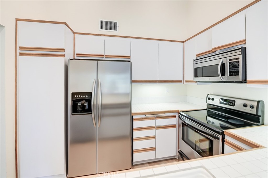 45 Campton Place Laguna Niguel, CA 92677 - Photo 14 of 22 a kitchen with stainless steel appliances and refrigerator