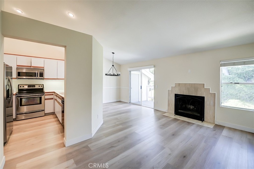 45 Campton Place Laguna Niguel, CA 92677 - Photo 6 of 22 a view of kitchen living room with wooden floor fireplace and windows