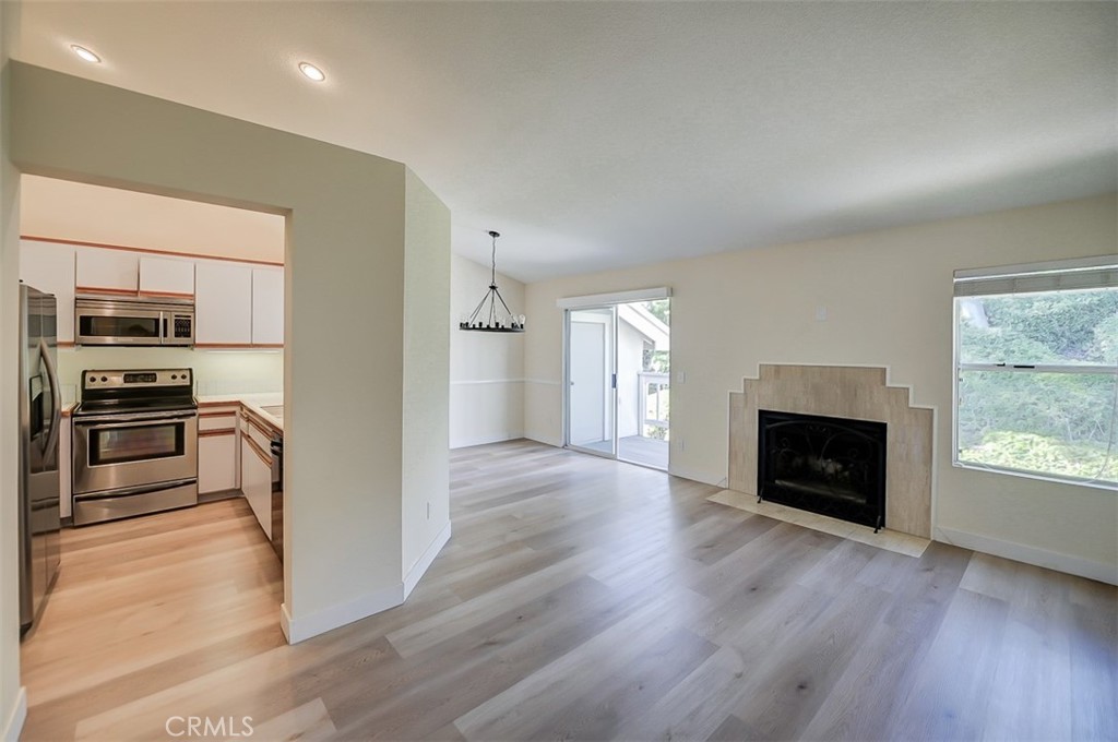 45 Campton Place Laguna Niguel, CA 92677 - Photo 10 of 22 a view of wooden floor fire place and windows in a room