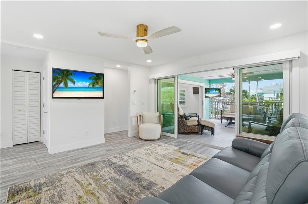 270 Dundee Road Fort Myers Beach, FL 33931 - Photo 7 of 48 Living room with ceiling fan, wood finished floors, and recessed lighting - Virtually Edited Image