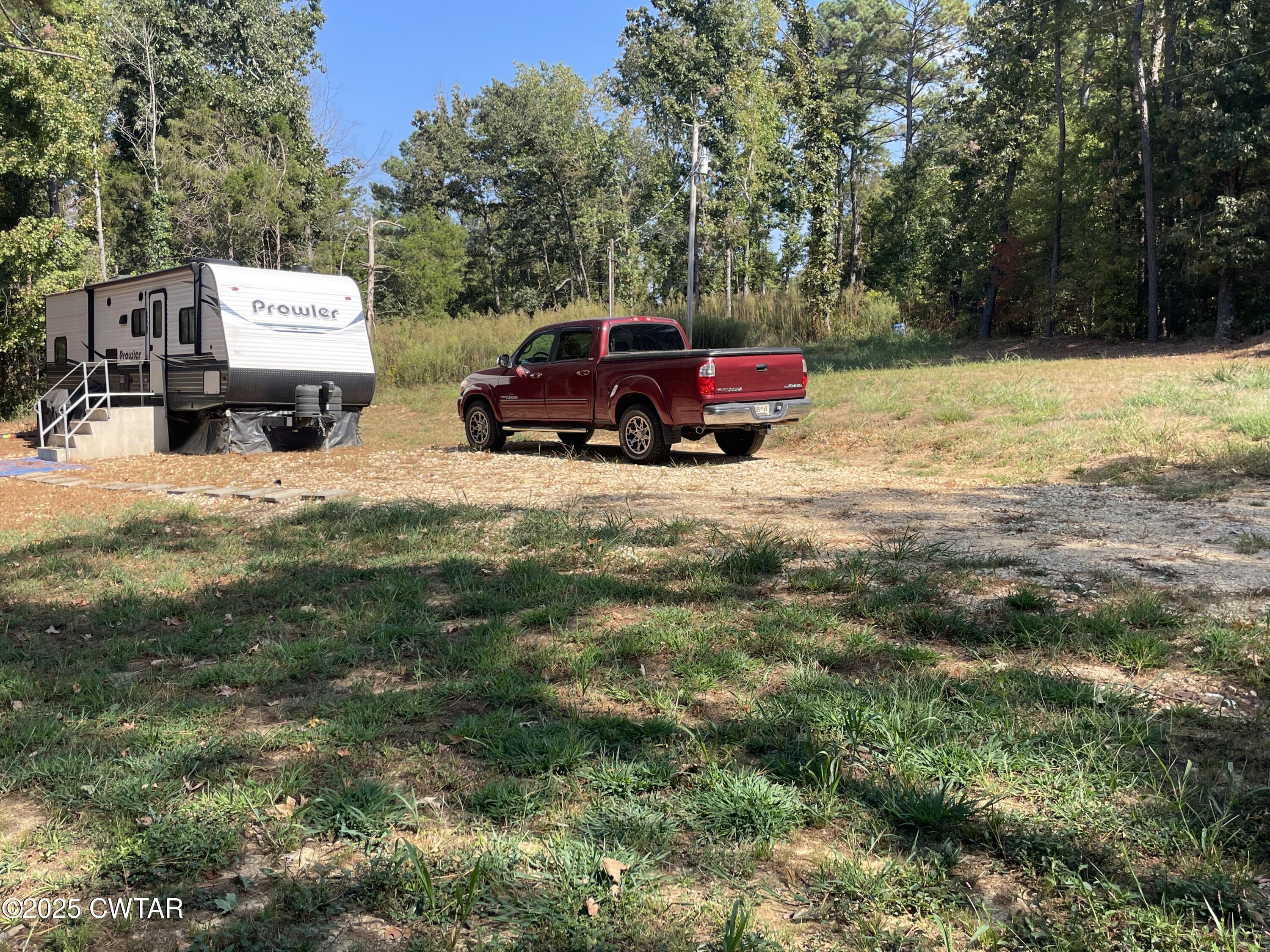 4500 Austin Springs Road Dukedom, TN 38226 - Photo 3 of 35 a backyard of a house with fire pit and trees