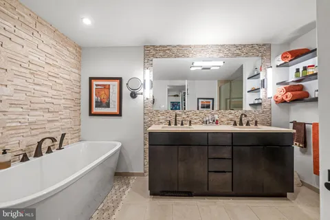 a bathroom with a sink double vanity and mirror