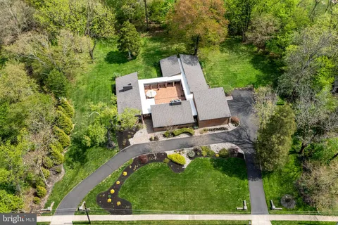 an aerial view of a houses with a yard