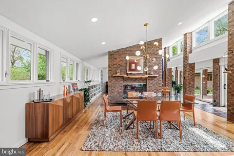 a dining room with furniture a rug and wooden floor