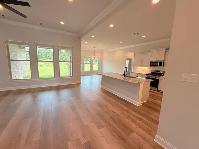 a view of kitchen with cabinets and wooden floor
