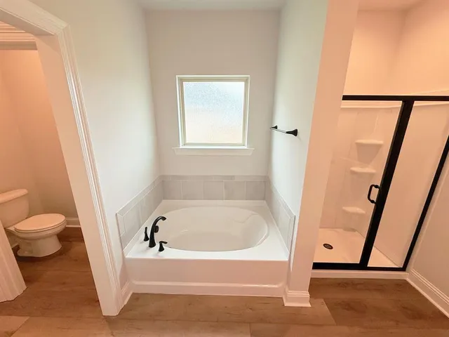 a white bath tub sitting next to a toilet