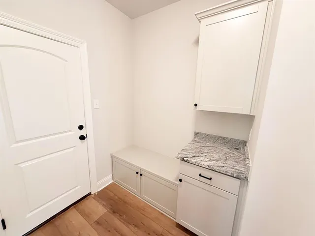 a bathroom with a granite countertop sink a mirror and a bathtub