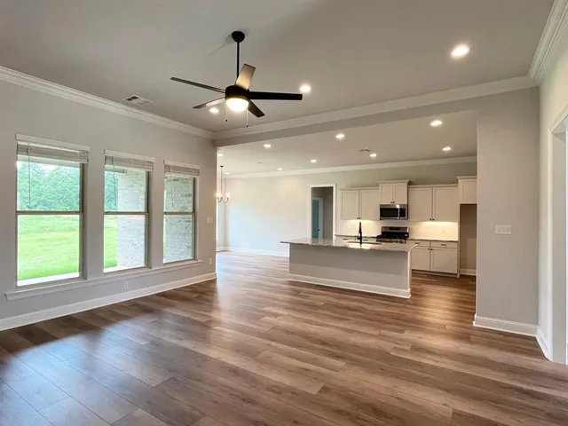 a view of kitchen and window with wooden floor