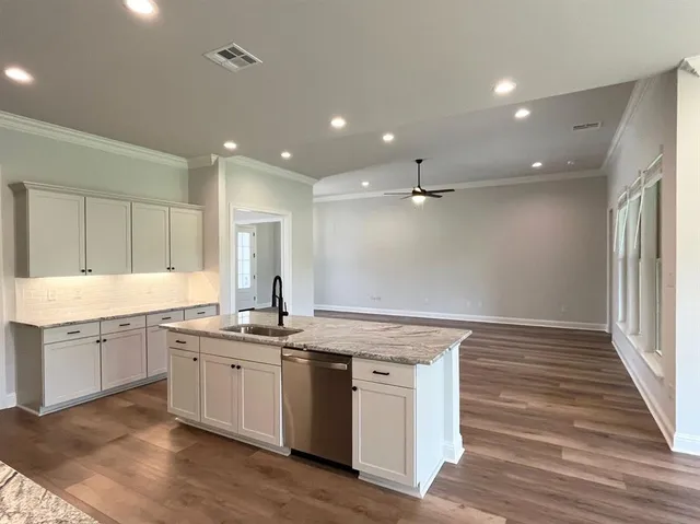 a kitchen with a sink stainless steel appliances and cabinets