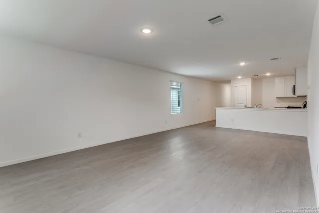 a view of a kitchen with a sink and a window