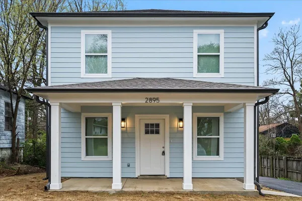 a view of a house with small yard