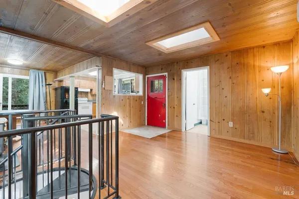 a view of a hallway with wooden floor and staircase
