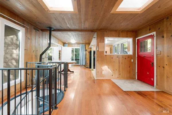 a view of a porch with wooden floor and a fireplace