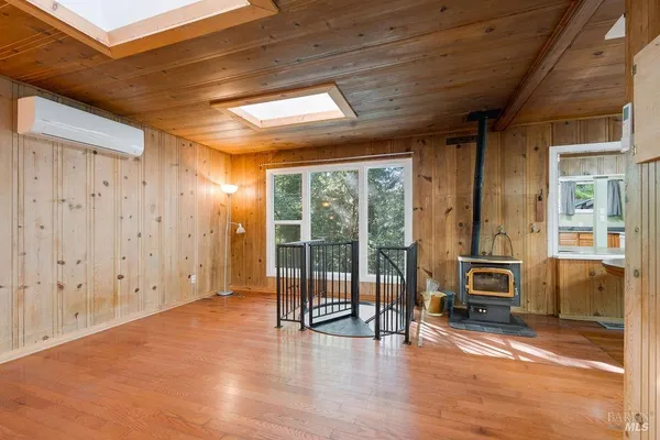 a view of a dining room with furniture large windows and wooden floor