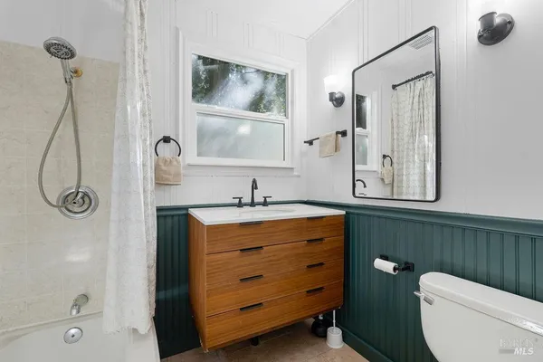 a kitchen with granite countertop a refrigerator and wooden cabinets