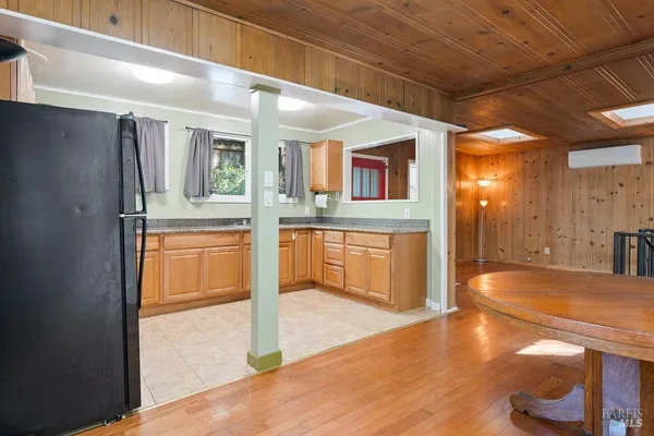 a kitchen with stainless steel appliances granite countertop white cabinets sink and window