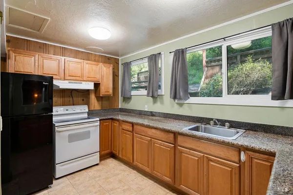 a kitchen with a sink a counter top space and cabinets