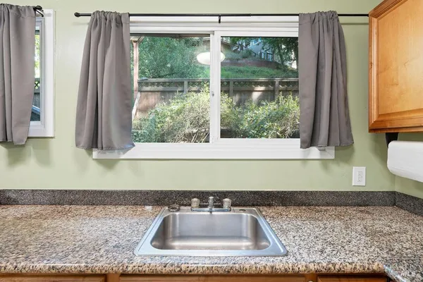 a kitchen with stainless steel appliances granite countertop a refrigerator and a sink