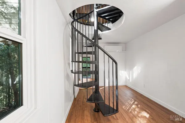 a view of staircase with wooden floor and a window