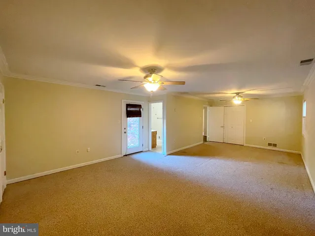 an empty room with windows and bathroom view