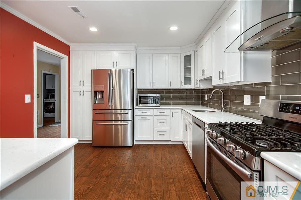 54 Holly Court Edison, NJ 08820 - Photo 1 of 25 a kitchen with a stove a refrigerator and a sink