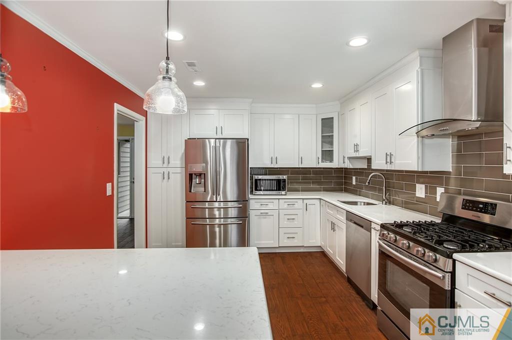 54 Holly Court Edison, NJ 08820 - Photo 2 of 25 a kitchen with stainless steel appliances a refrigerator sink and stove