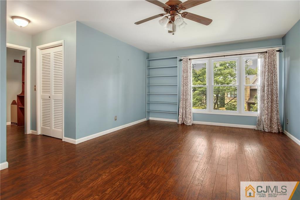 54 Holly Court Edison, NJ 08820 - Photo 11 of 25 a view of an empty room with wooden floor and a window