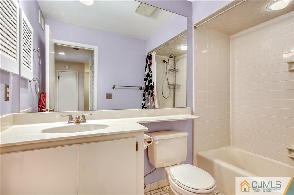 54 Holly Court Edison, NJ 08820 - Photo 17 of 25 a bathroom with a sink vanity mirror toilet and bathtub