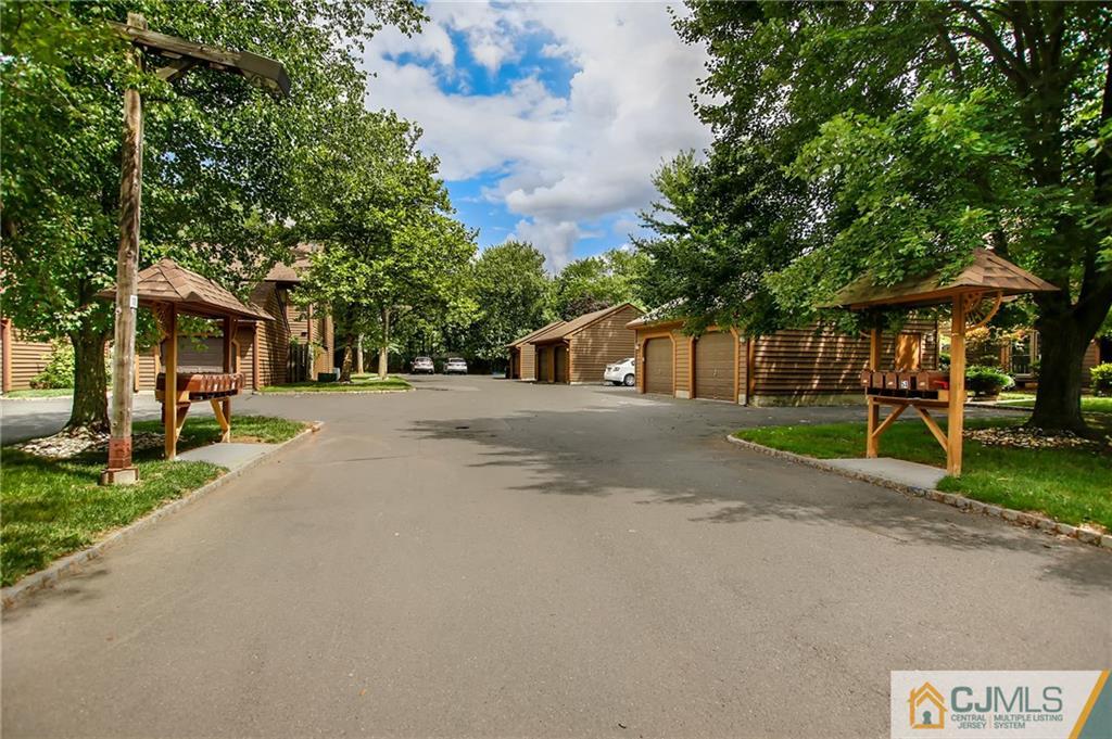 54 Holly Court Edison, NJ 08820 - Photo 21 of 25 a front view of a house with a yard and trees