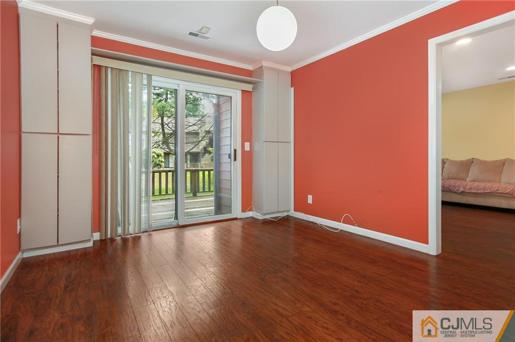 54 Holly Court Edison, NJ 08820 - Photo 4 of 25 a view of an empty room with wooden floor and a window