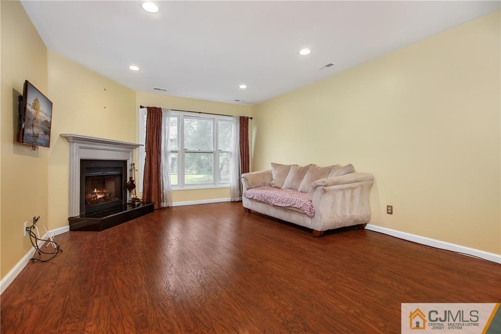 54 Holly Court Edison, NJ 08820 - Photo 5 of 25 a living room with furniture and a fireplace