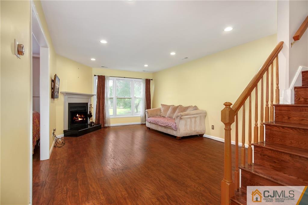 54 Holly Court Edison, NJ 08820 - Photo 6 of 25 a living room with furniture and a fireplace