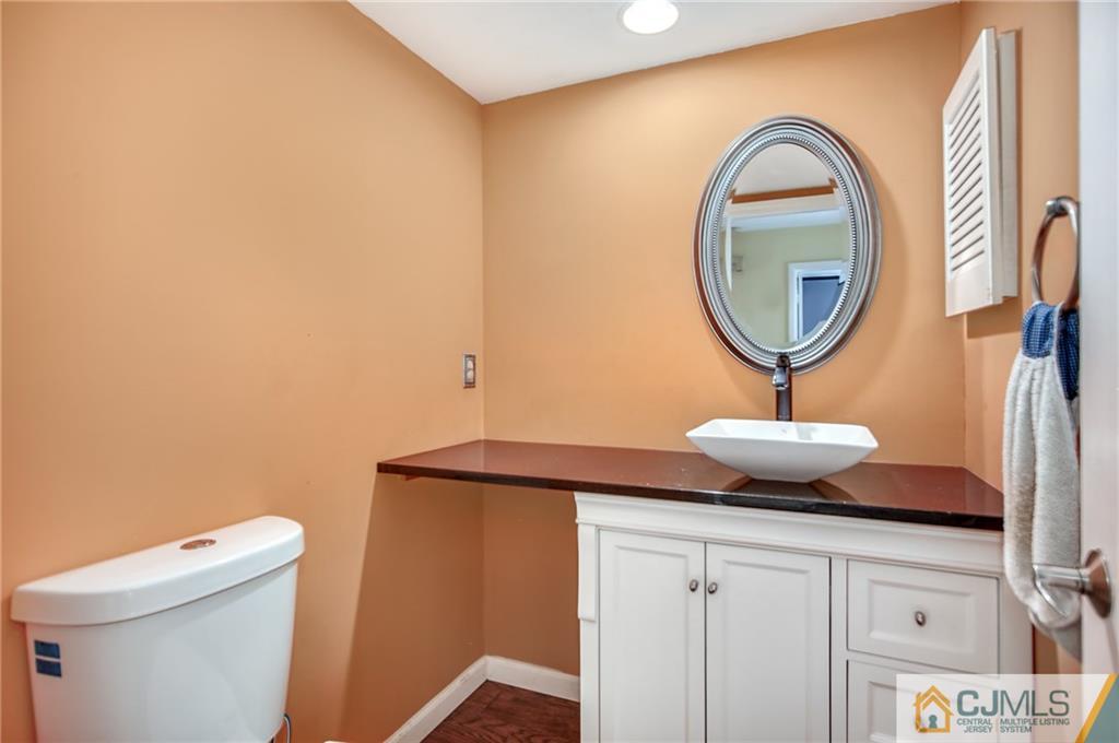 54 Holly Court Edison, NJ 08820 - Photo 7 of 25 a bathroom with a sink and a mirror