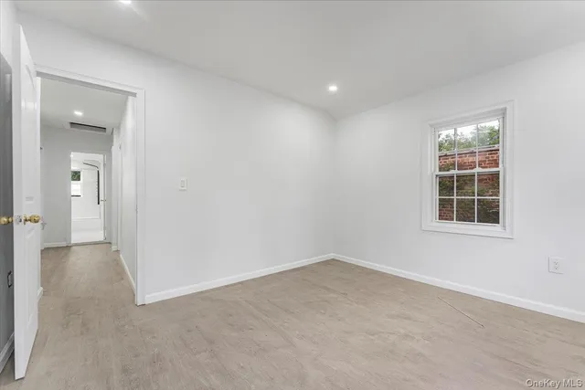 an empty room with windows and closet