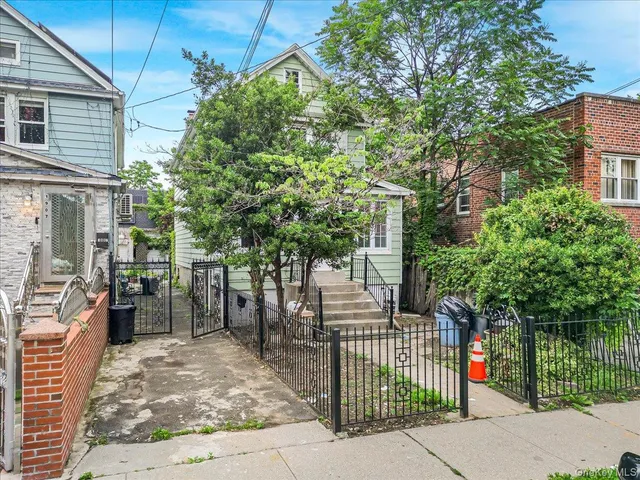 a view of street along with house and trees