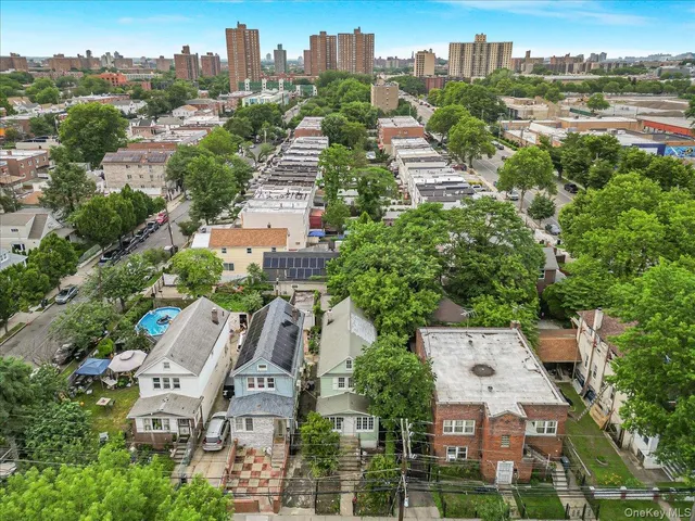 an aerial view of residential houses with city view
