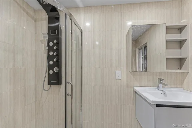 a bathroom with a shower sink and mirror