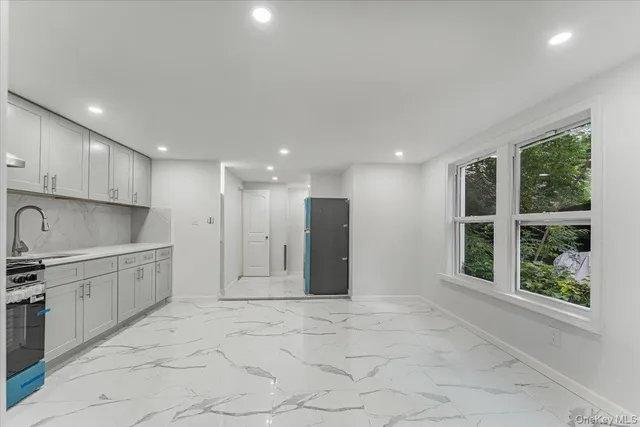 a view of a kitchen with a sink and a window